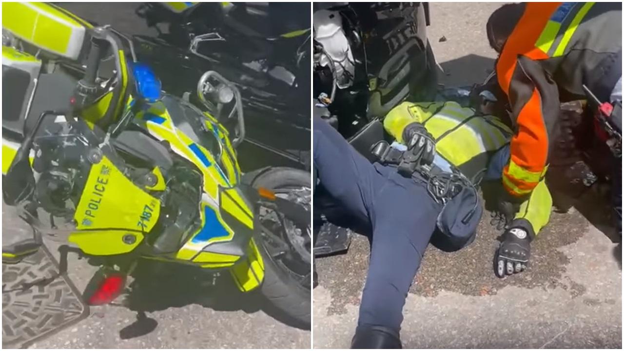 涉事交通警員倒臥地面,救護員為他檢查傷勢。(網片截圖)